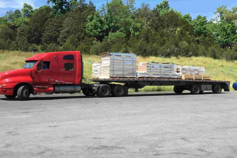 truck carrying walk-in coolers and freezers