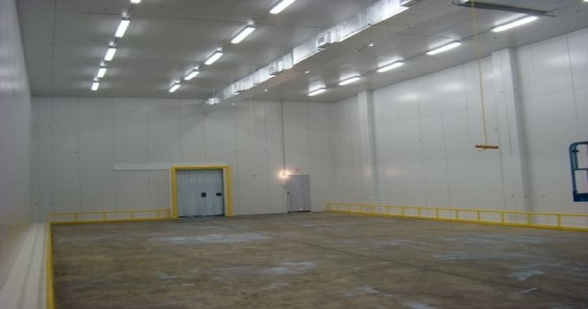 empty refrigerated warehouse with fluorescent lighting