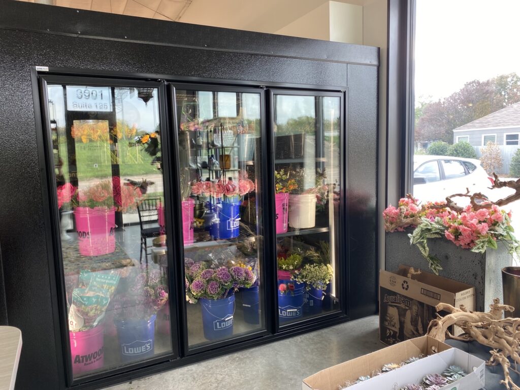 Exterior of floral cooler with glass doors to showcase different flower options