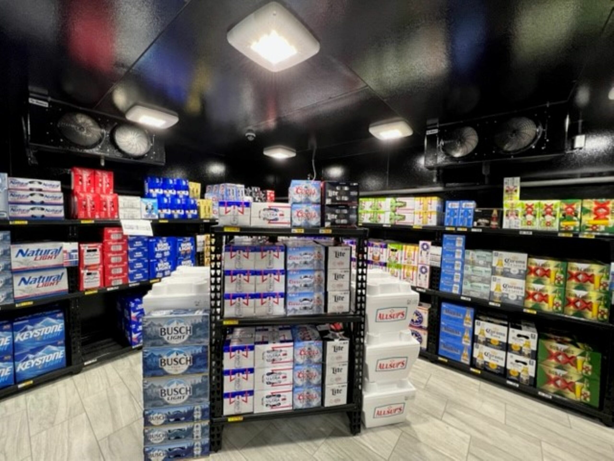 Beer stacked on shelves in a walk-in beer cooler