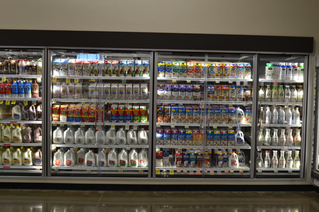 grocery store cooler stocked with dairy products