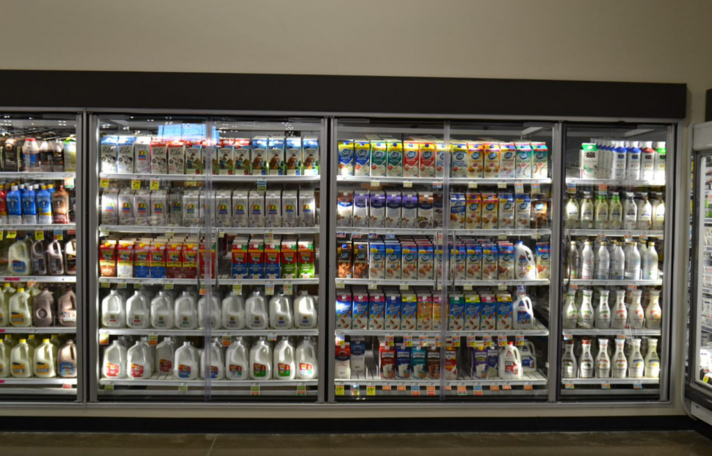 grocery store cooler with reach in glass doors to showcase merchandise