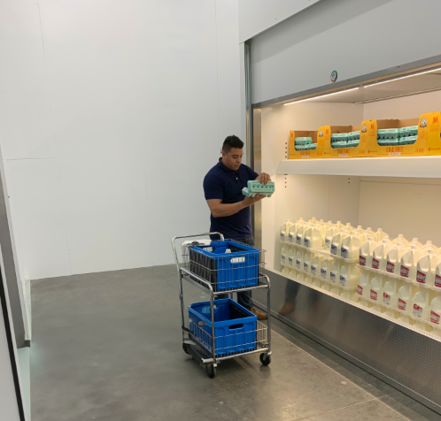 Ecommerce Grocery Fulfilment specialists picking grocery items from front loaded cooler improving online grocery fulfillment picking times and costs