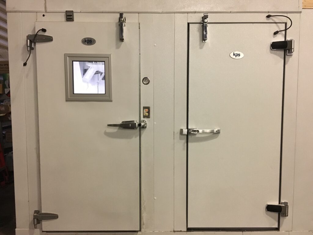 Metal doors, one with windows one without to showcase different doors used in scientific laboratories