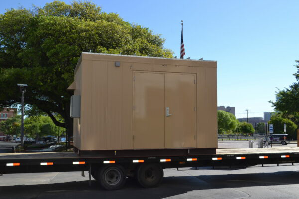 Metal enclosure on truck tailer for shipping to installation site