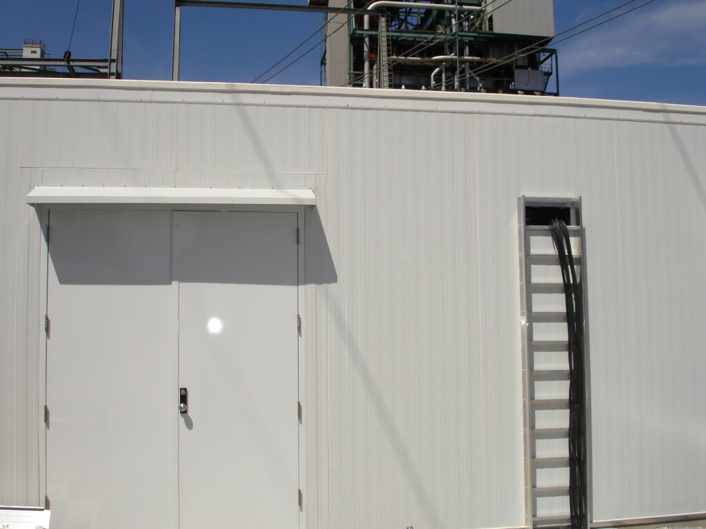 Outdoor metal enclosure installed to protect utility equipment.